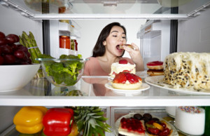 woman-eating-from-fridge-630x450