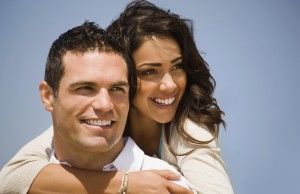 Young man giving piggyback to woman